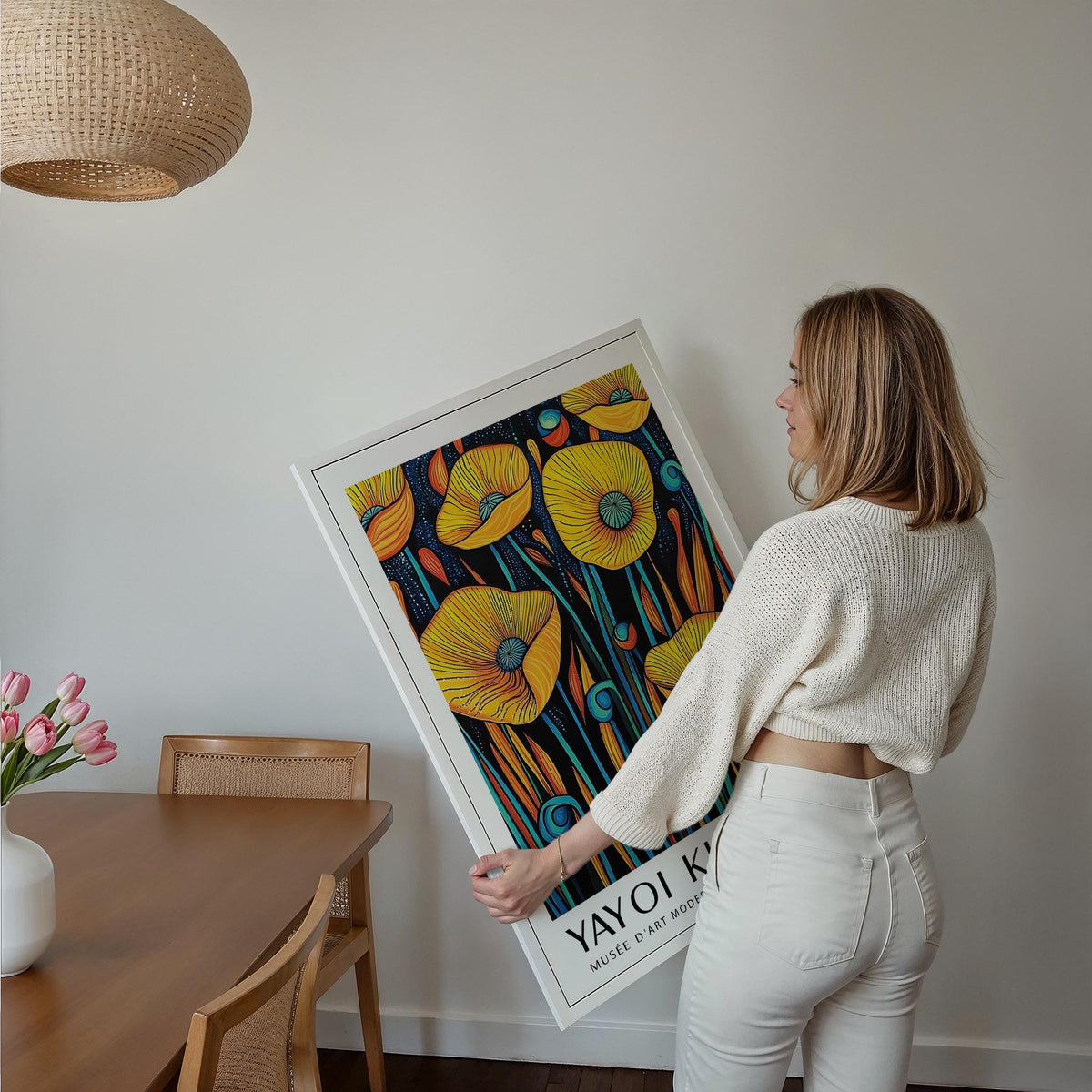 Poppies wall art held by woman showing yellow poppies and blue green stems in a white frame
