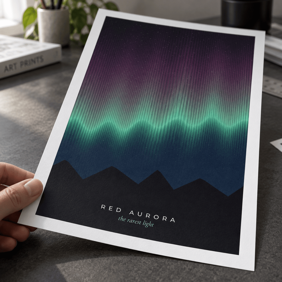 Close view of the crimson and green northern lights print on smooth matte paper