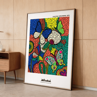Framed Colorful Butterfly Art Print leaning against a wooden wall near a cabinet