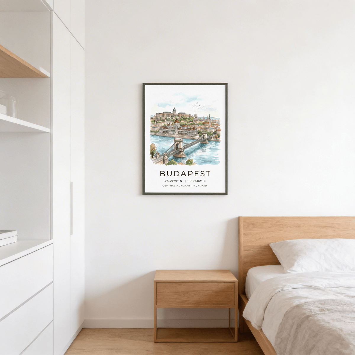 Budapest Cityscape wall art above a wooden bedside table in a bedroom with white walls