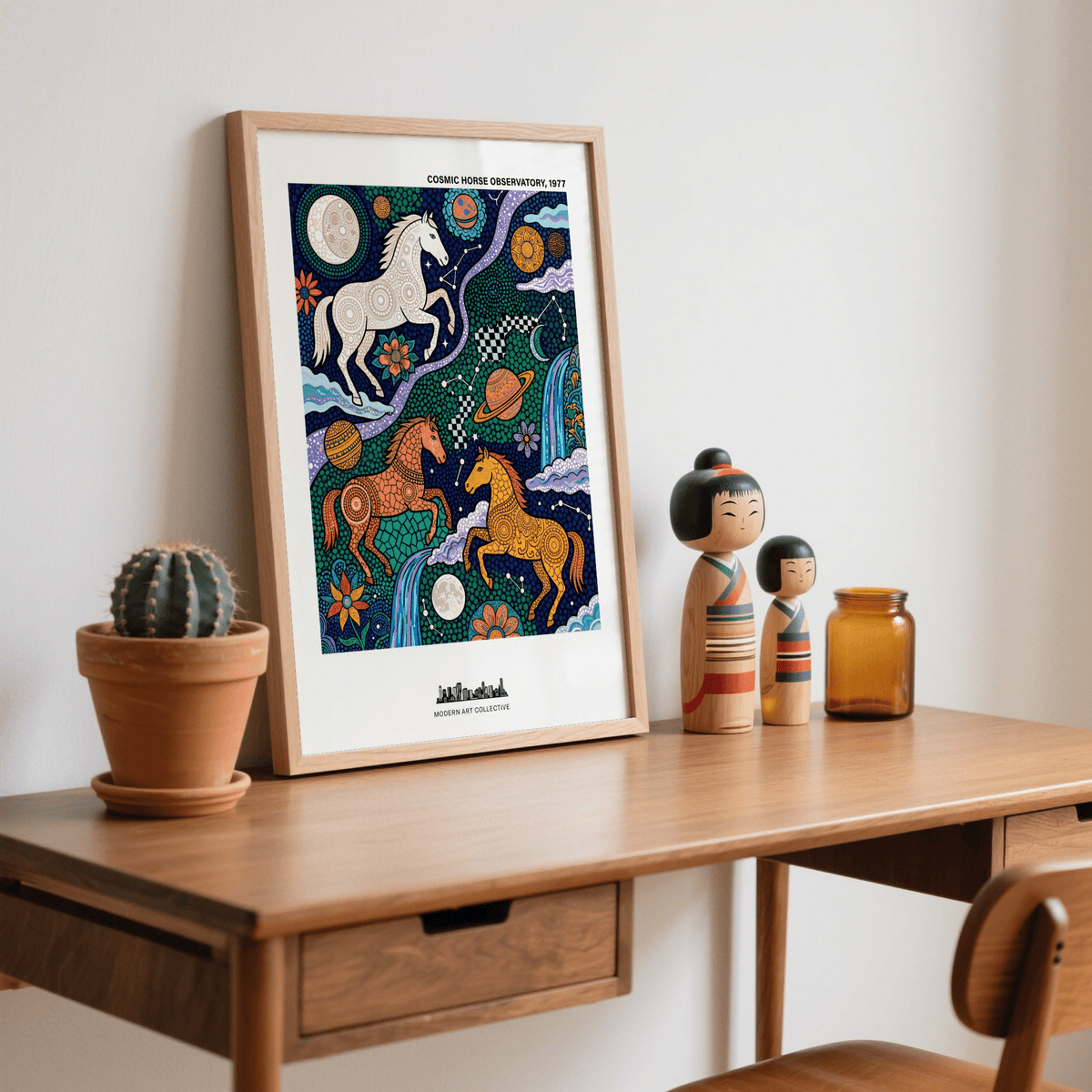 Cosmic Horse Art Print with folk-art horses in orange, white and yellow colours leaning on a wooden desk with decorative objects