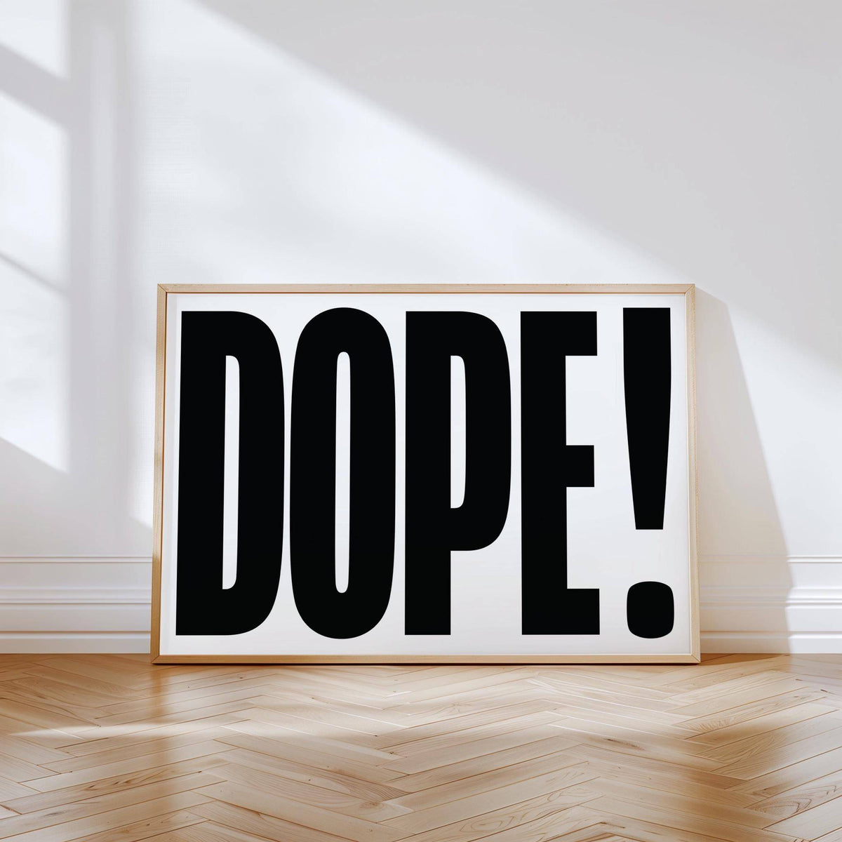 Big Text Poster leaning on a wall with black dope typography on white background and wooden floor