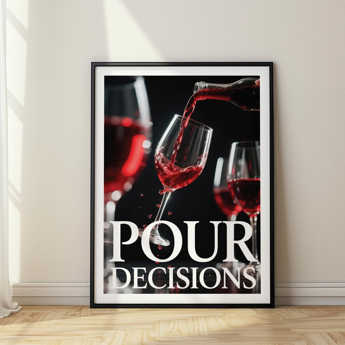 Framed print close-up of red wine pouring into a glass with typographic text on white wall