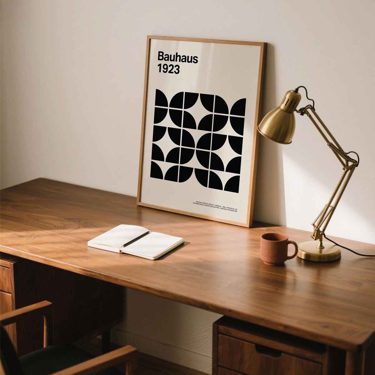 Picture for Home Office leaning on a wooden desk near a brass desk lamp and a cup