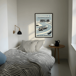 Abu Dhabi Race Circuit Poster print on a bedroom wall with a wooden side table and teapot