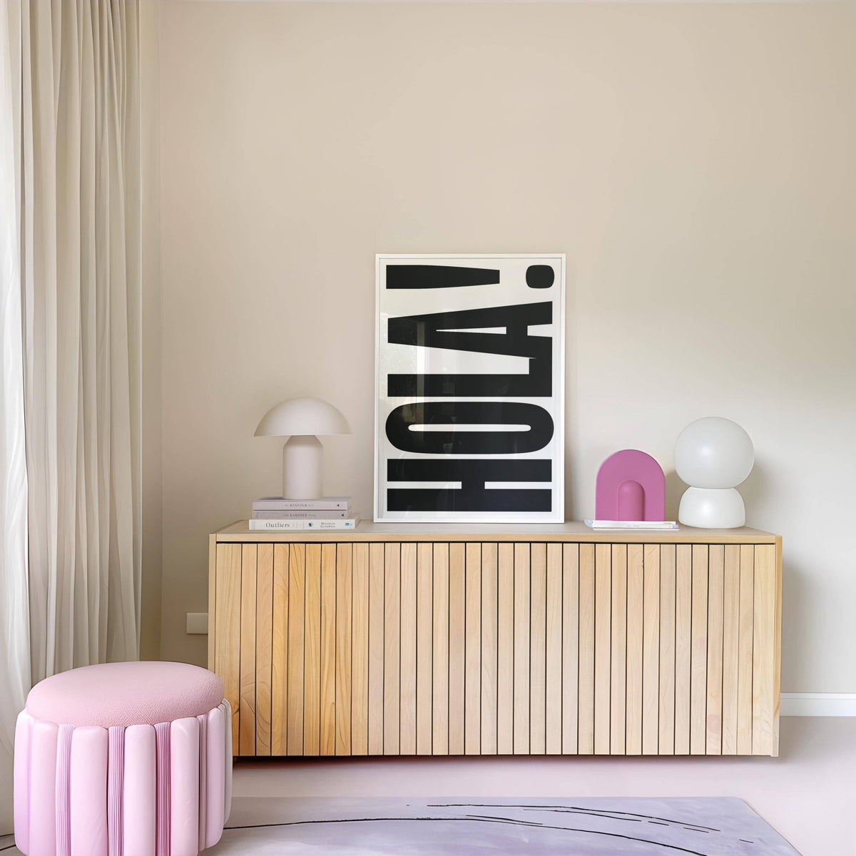 Typographic Posters print leaning on a wooden sideboard with pink and white decor in a minimalist room