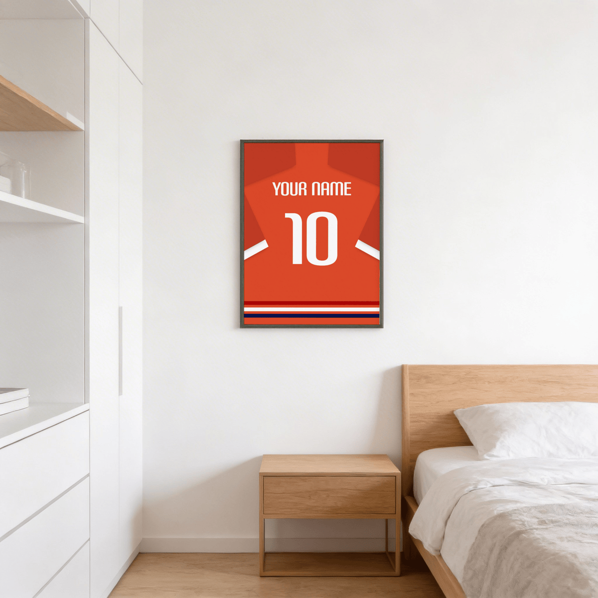 Football Shirt Poster in Orange-Red with White Number hanging above a wooden bedside table in a bedroom