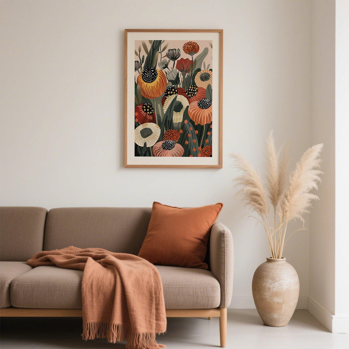 Burnt Orange wall art with abstract orange and cream flowers above a sofa with a burnt orange cushion
