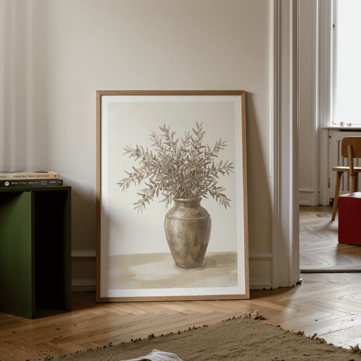 Print leaning on floor of olive branch decor showing brown watercolour leaves next to a green cube shelf