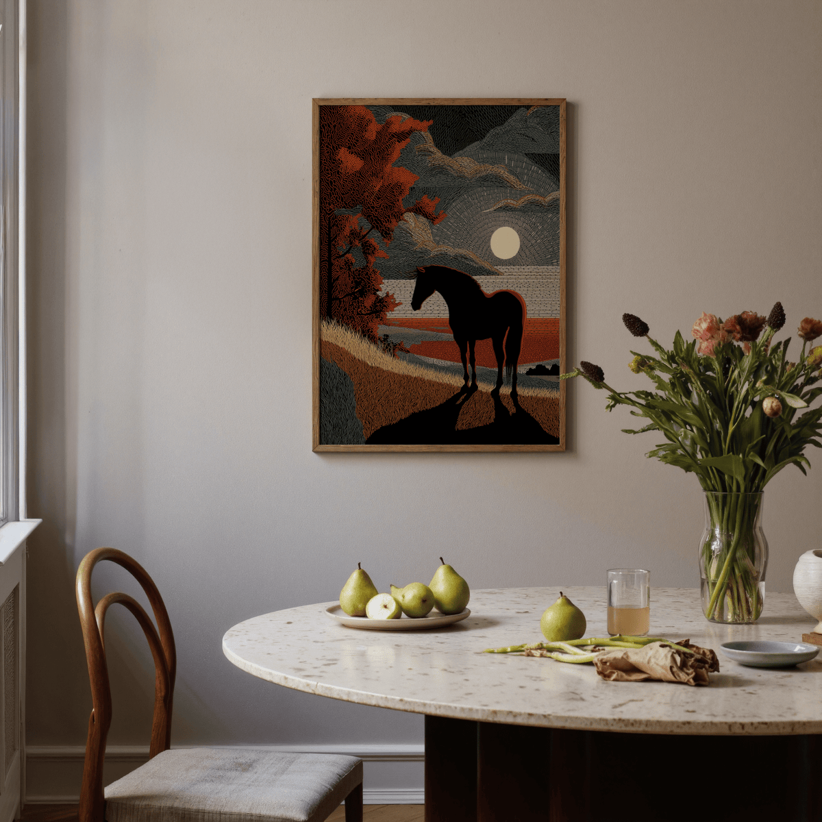 Horse silhouette art hanging on a wall above a dining table with fruit and flowers