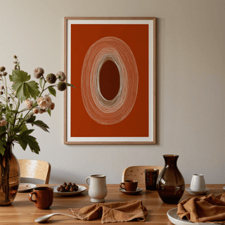 Abstract Line Drawing Poster with concentric oval lines in earthy orange and cream above a dining table with crockery and brown vases