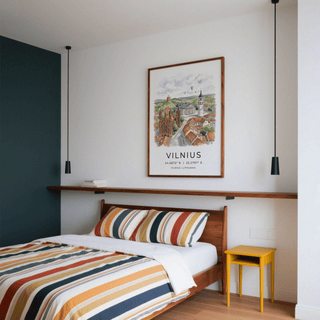 Vilnius City Print hung above a bed with a striped cushion and wooden frame in a bedroom