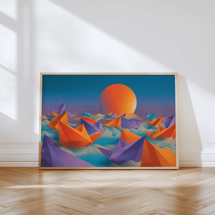 Print leaning on floor of origami wall art with orange and purple boats under an orange sun in soft light