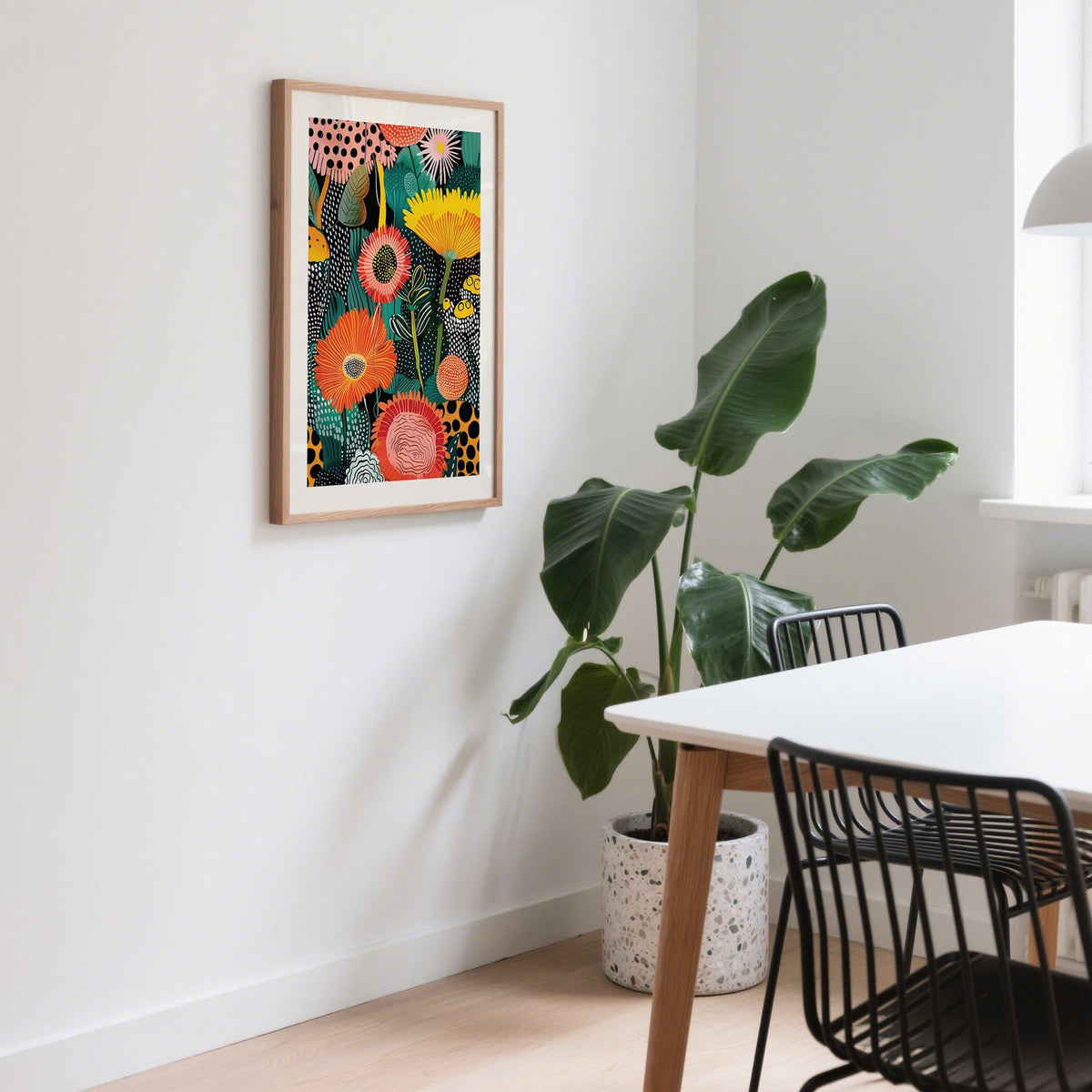 Beautiful Flower Art print on a wall with colourful abstract flowers and leaves beside a dining table with black chairs