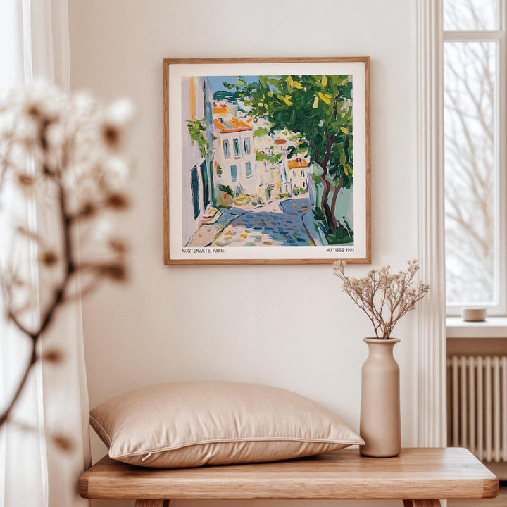 French artwork prints framed print of a colourful Paris street scene with green tree above a wooden table with cushion and vase