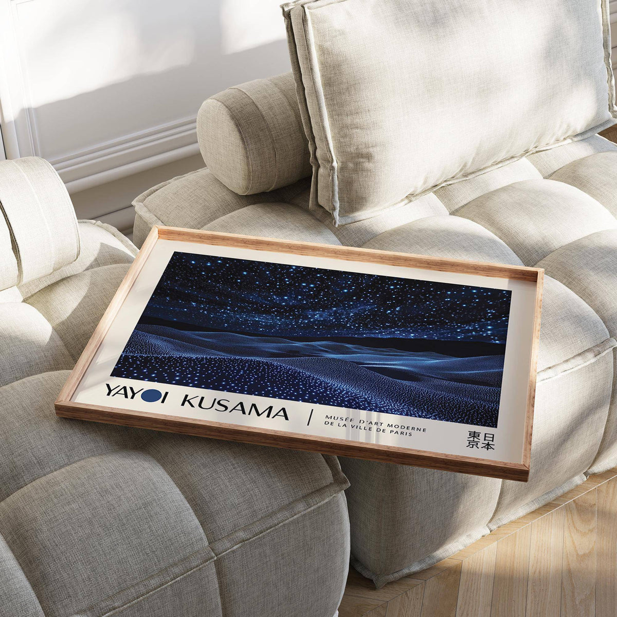 Night Sky Wall Art print resting on a beige cushioned seat with starry blue waves and text