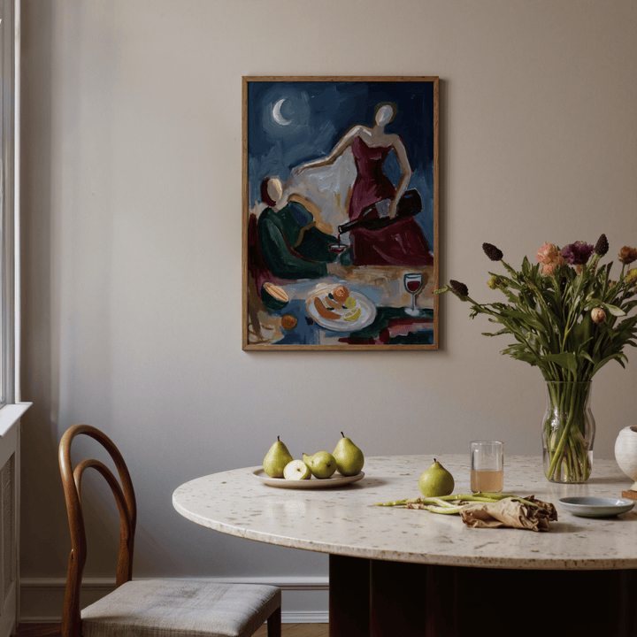 Couple Dinner wall art of a woman in red pouring wine above a table with pears and flowers