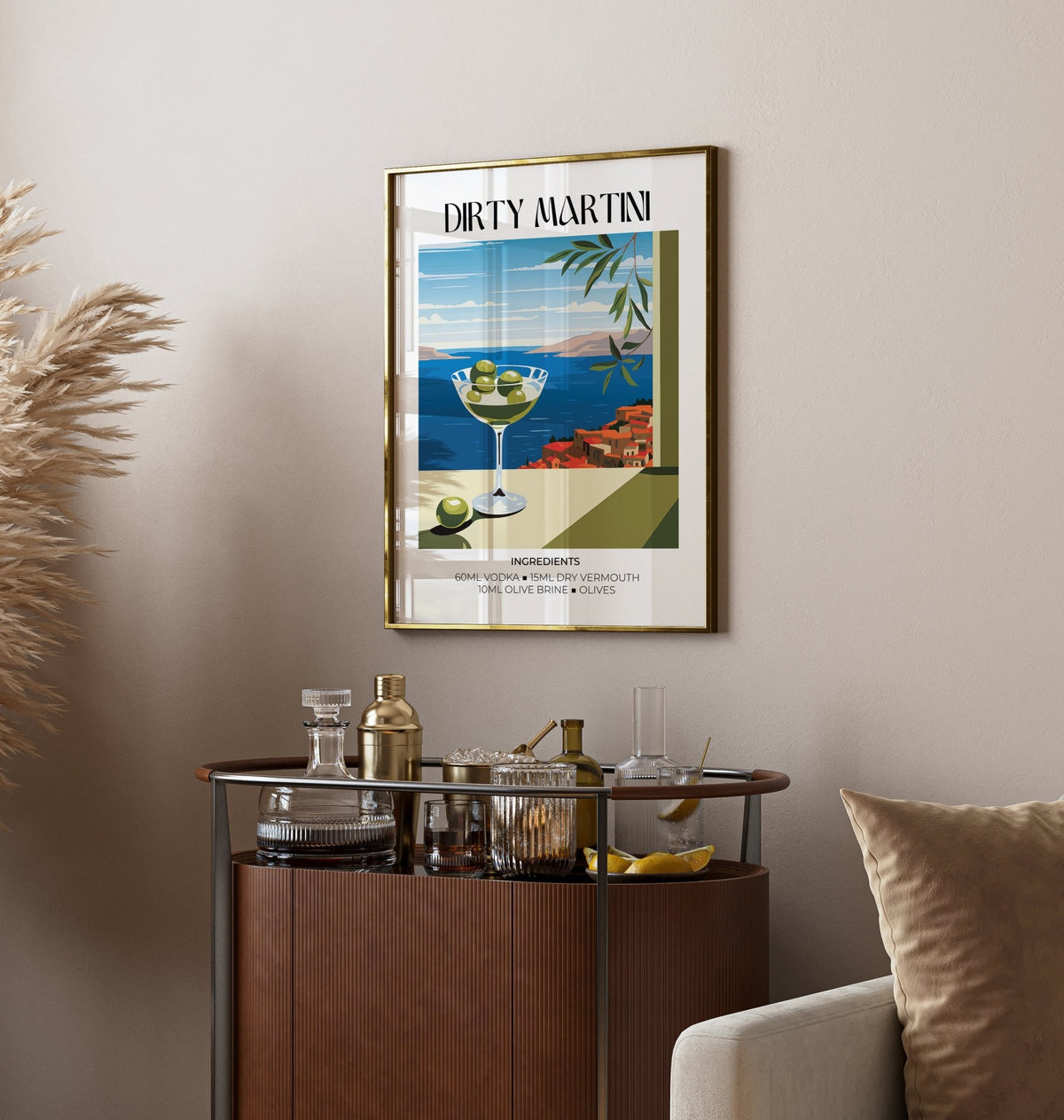 Framed print of a dirty martini cocktail illustration above a home bar with glassware and accessories