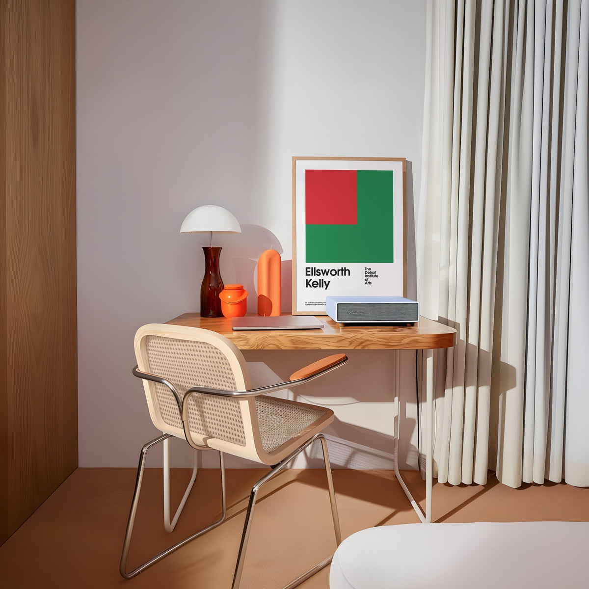 Office Poster with green and red geometric shapes framed on a desk with white lamp and chair