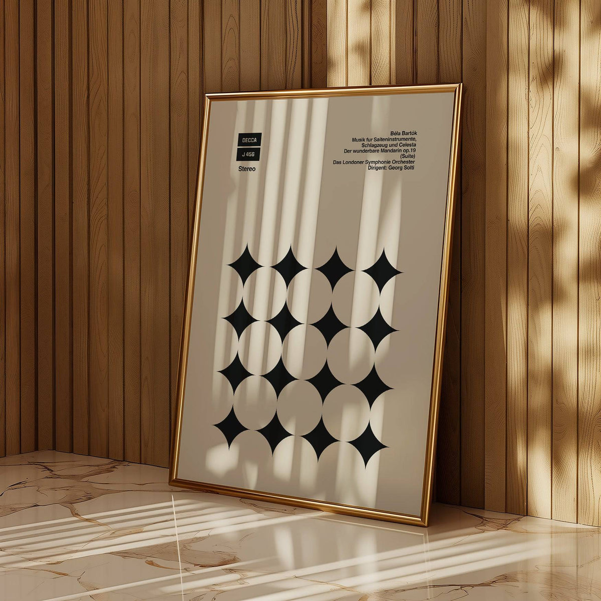 Framed Graphic Art Poster with black star shapes and text leaning on a marble floor with wood panel wall
