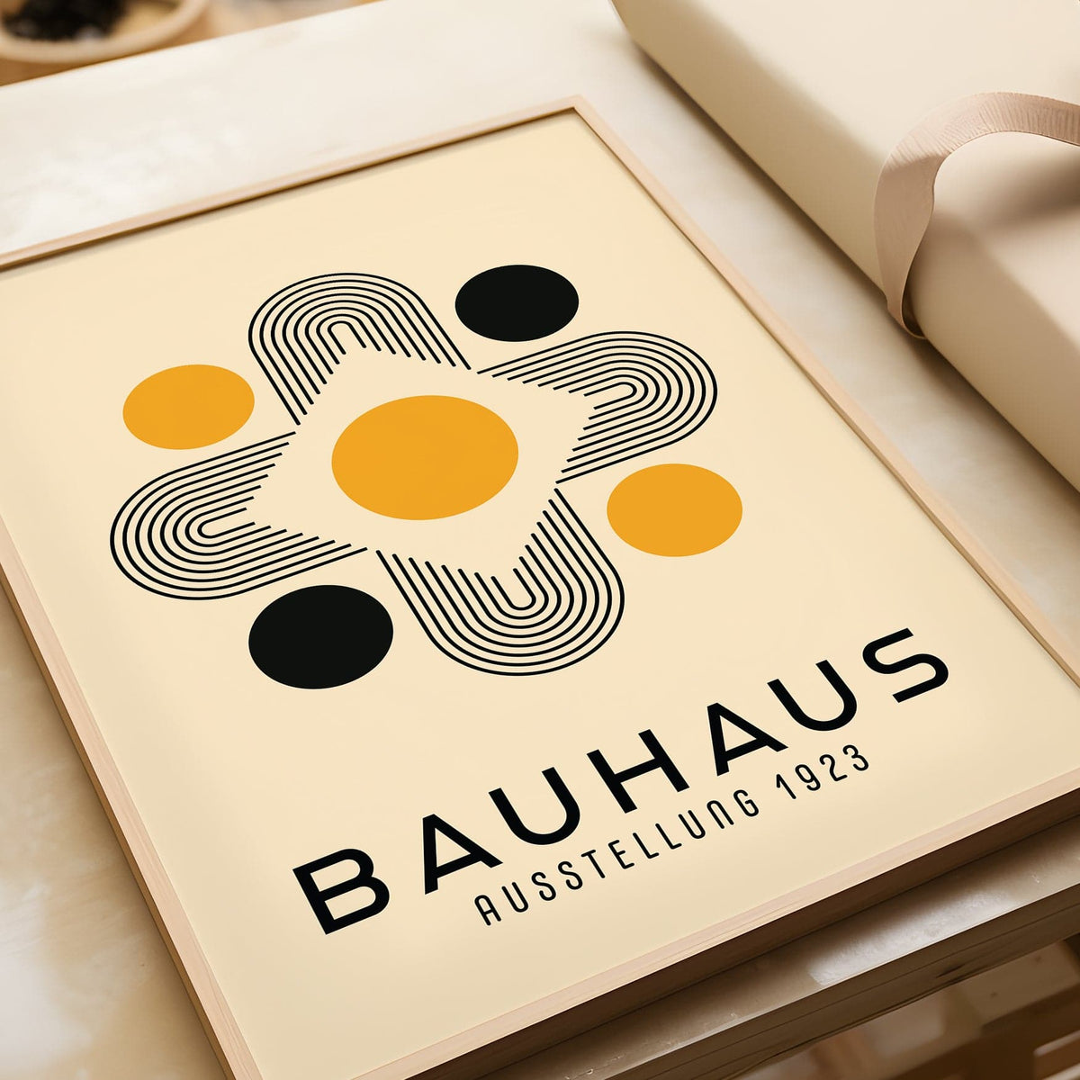 Framed Geometric Abstract wall art with black and gold shapes on cream background close-up