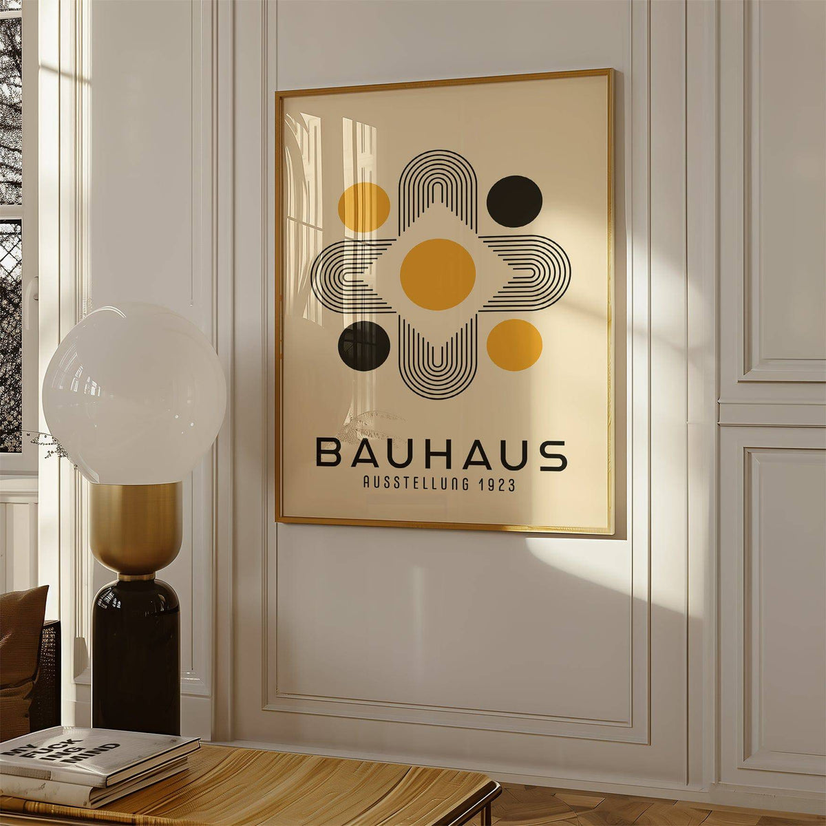 Geometric Abstract wall art with golden and black Bauhaus shapes hanging on a white wall near a modern lamp