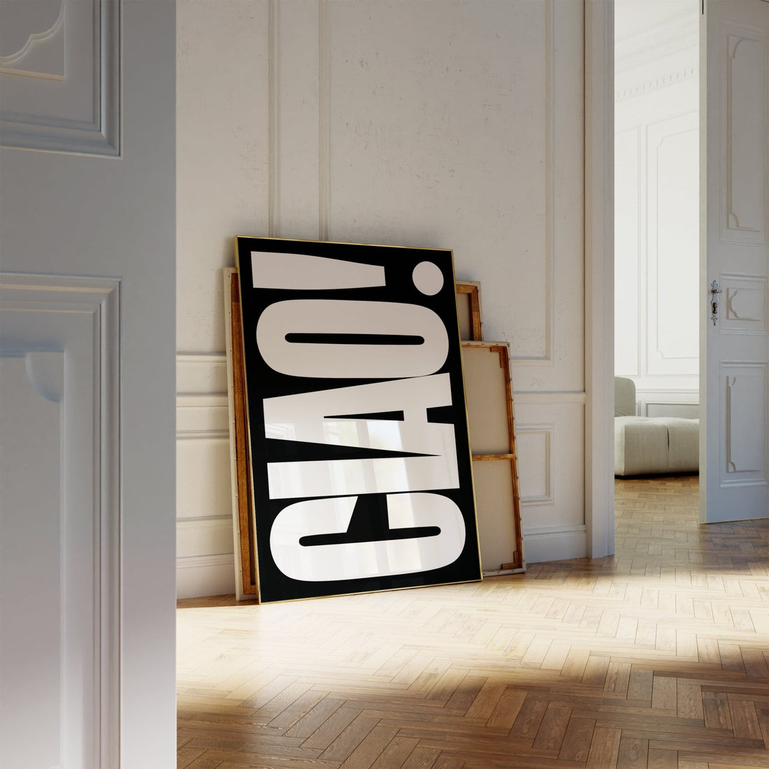 Bold black and white print reading CIAO leaning against a panelled wall in a bright hallway with herringbone floors