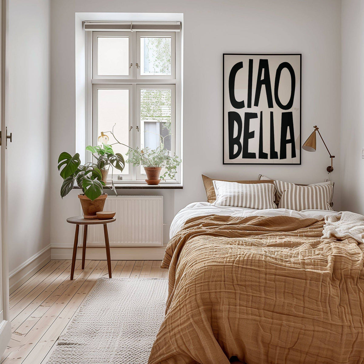 Print on a wall in a bedroom with black and white typography ciao bella poster above a bed