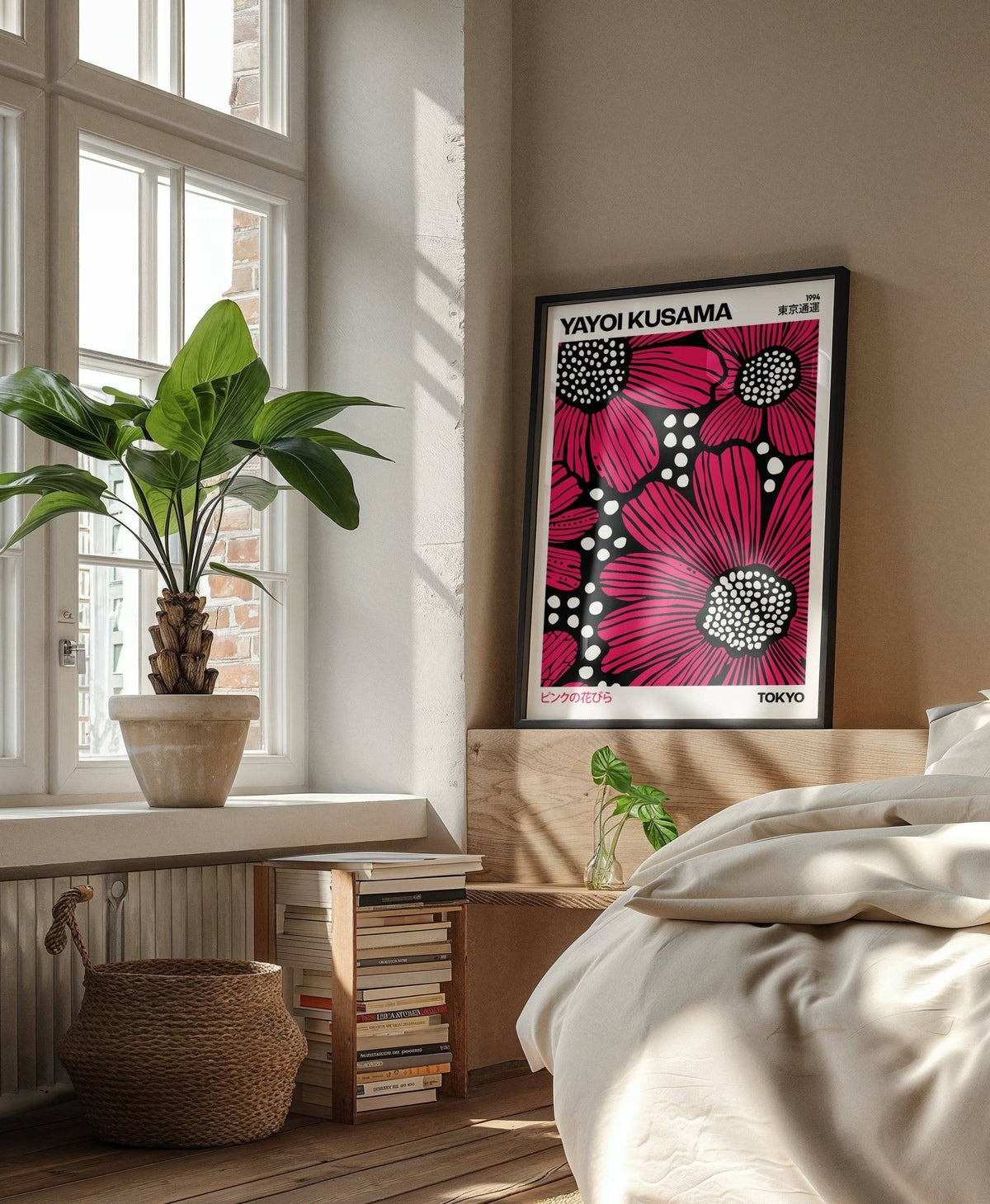 Print on a wall in a bedroom showing pop-art red daisies with black and white details near a potted plant