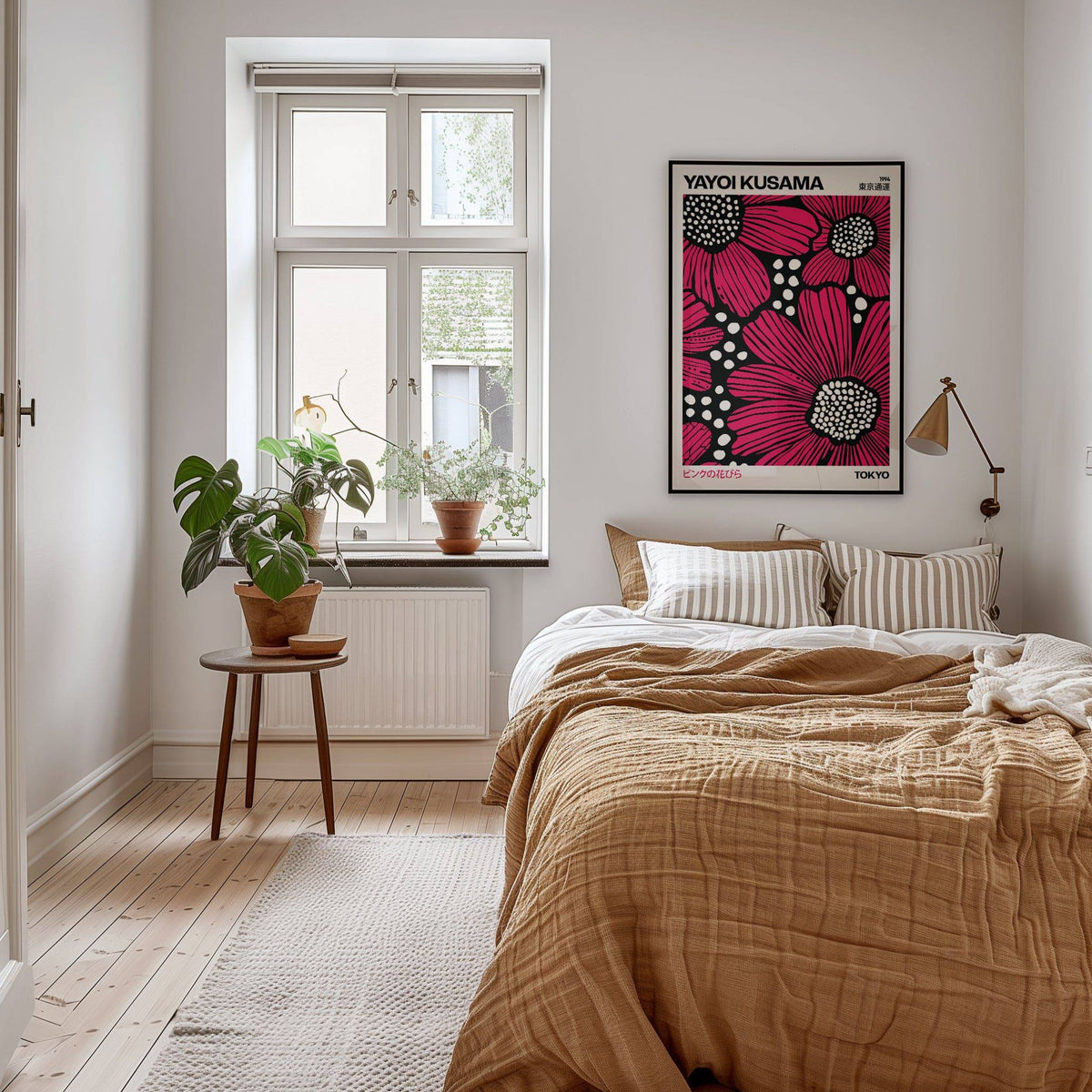 Pink Posters on a wall in a bedroom featuring bright pink daisies with black and white details above a bed