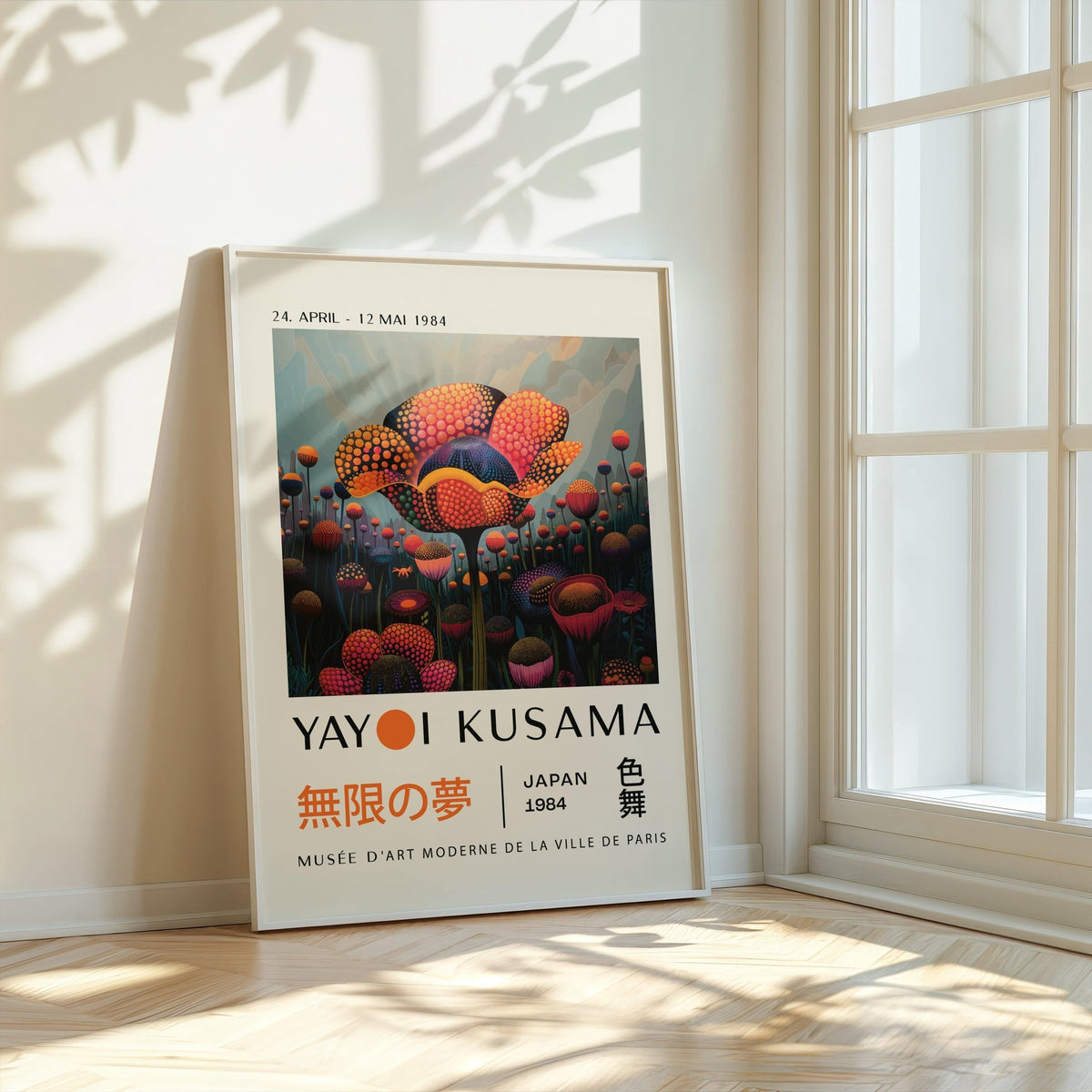 Colourful flower prints leaning against a wall with sunlight and a white window frame nearby