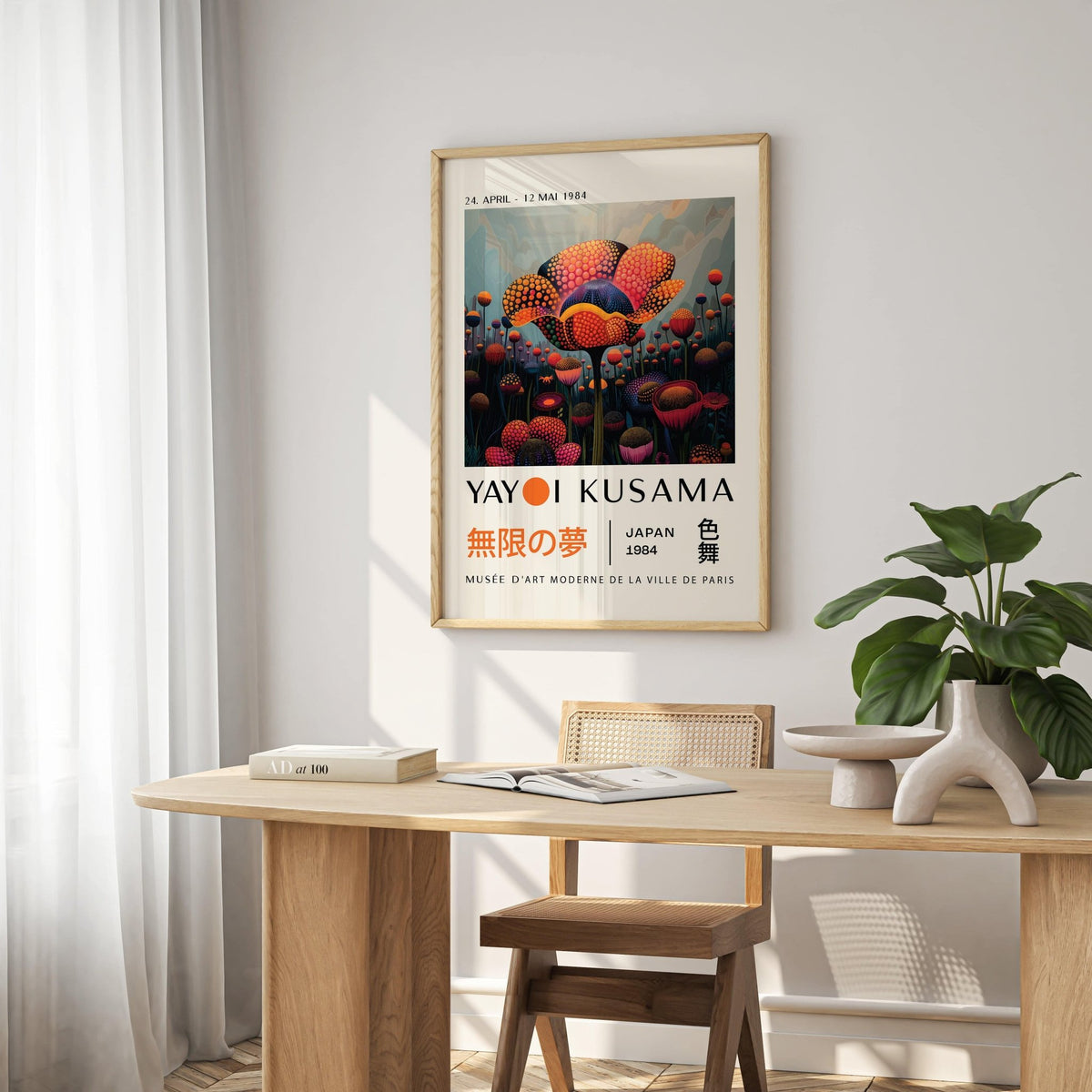 Colourful Flower Prints on a dining room wall with bright abstract floral patterns and a green plant