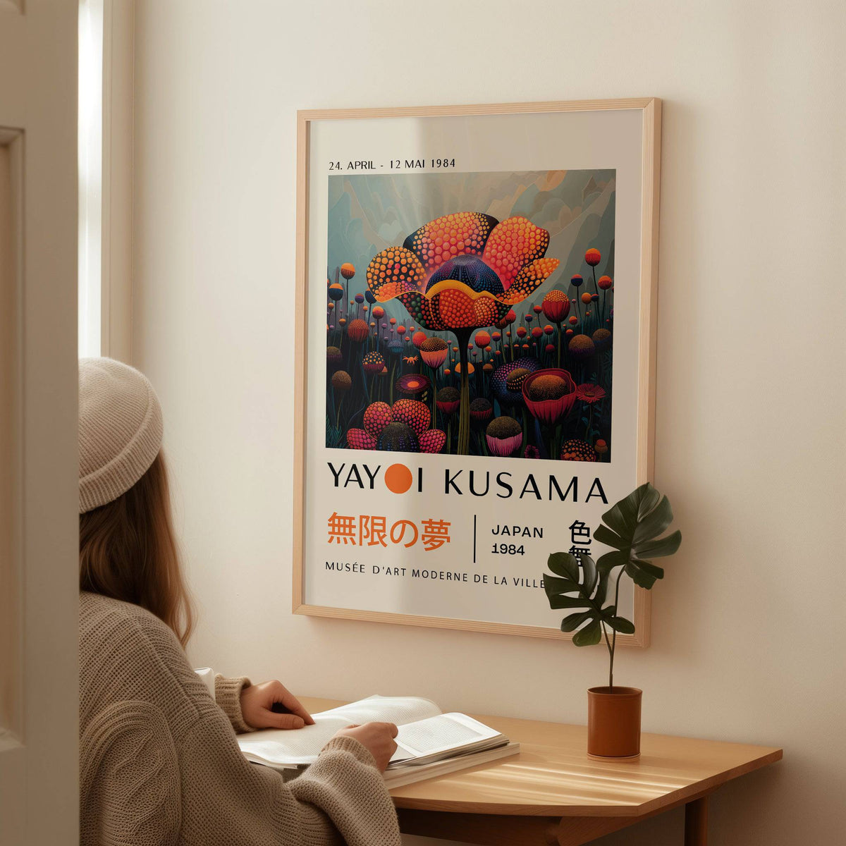 Colourful Flower Prints framed print close-up with bright orange and purple abstract flowers above a wooden desk with a plant