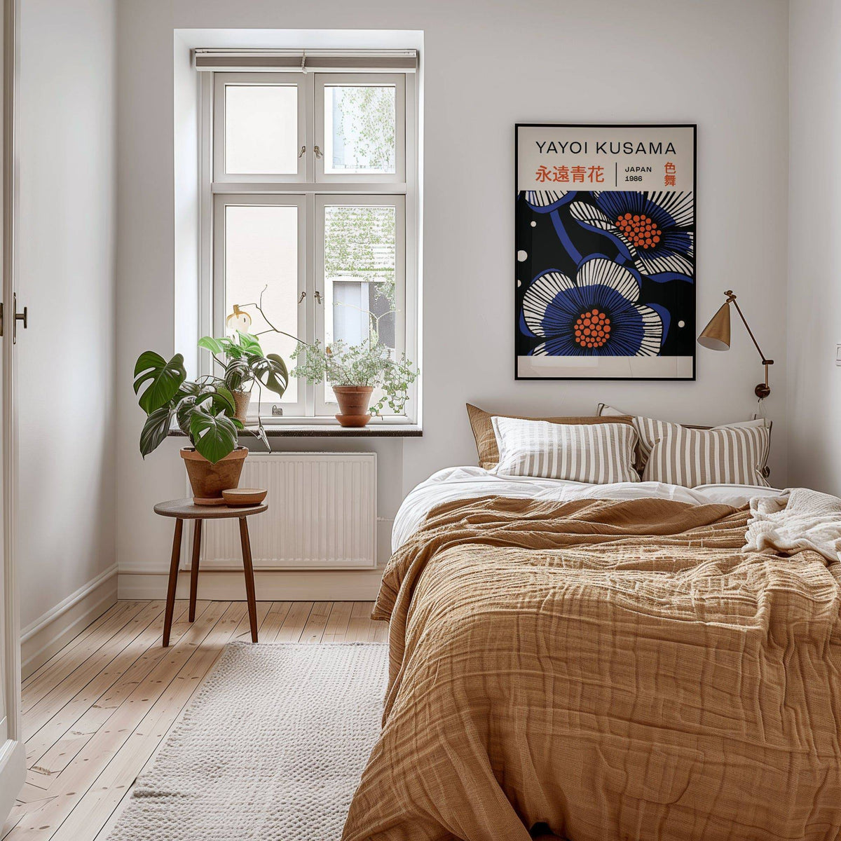 Blue Flower Poster print with graphic blue and white flowers hung above a bed with brown bedding