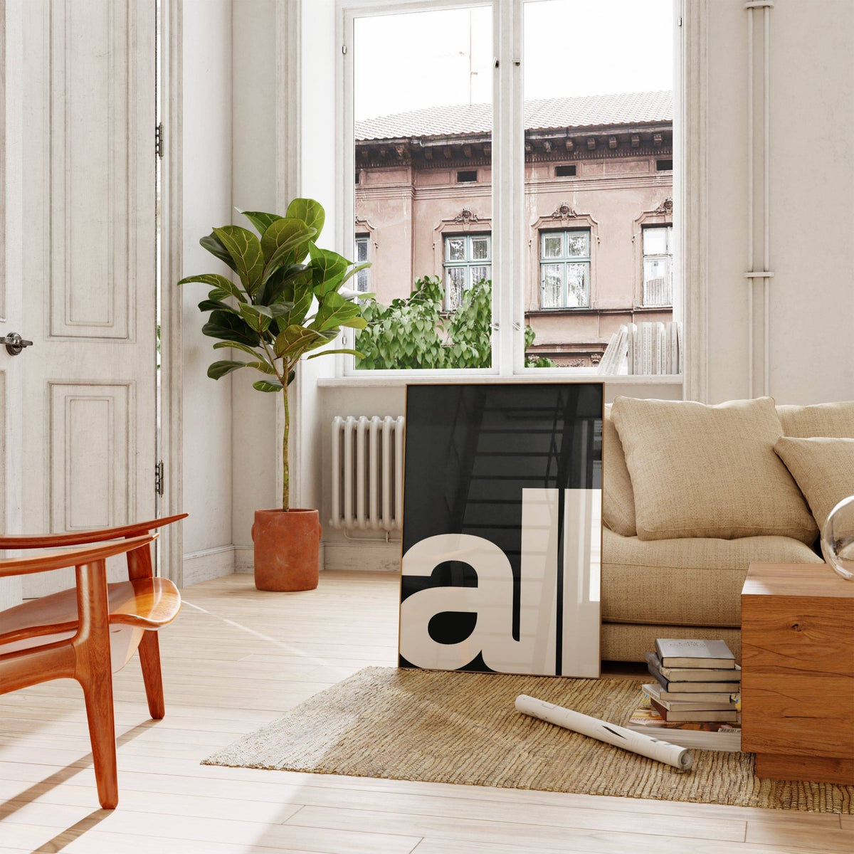Typography art prints leaning print with black background and white all text by a beige sofa and houseplant