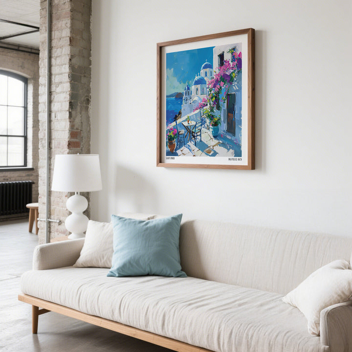 Santorini wall art prints above beige sofa with blue cushion in a bright room with exposed brick