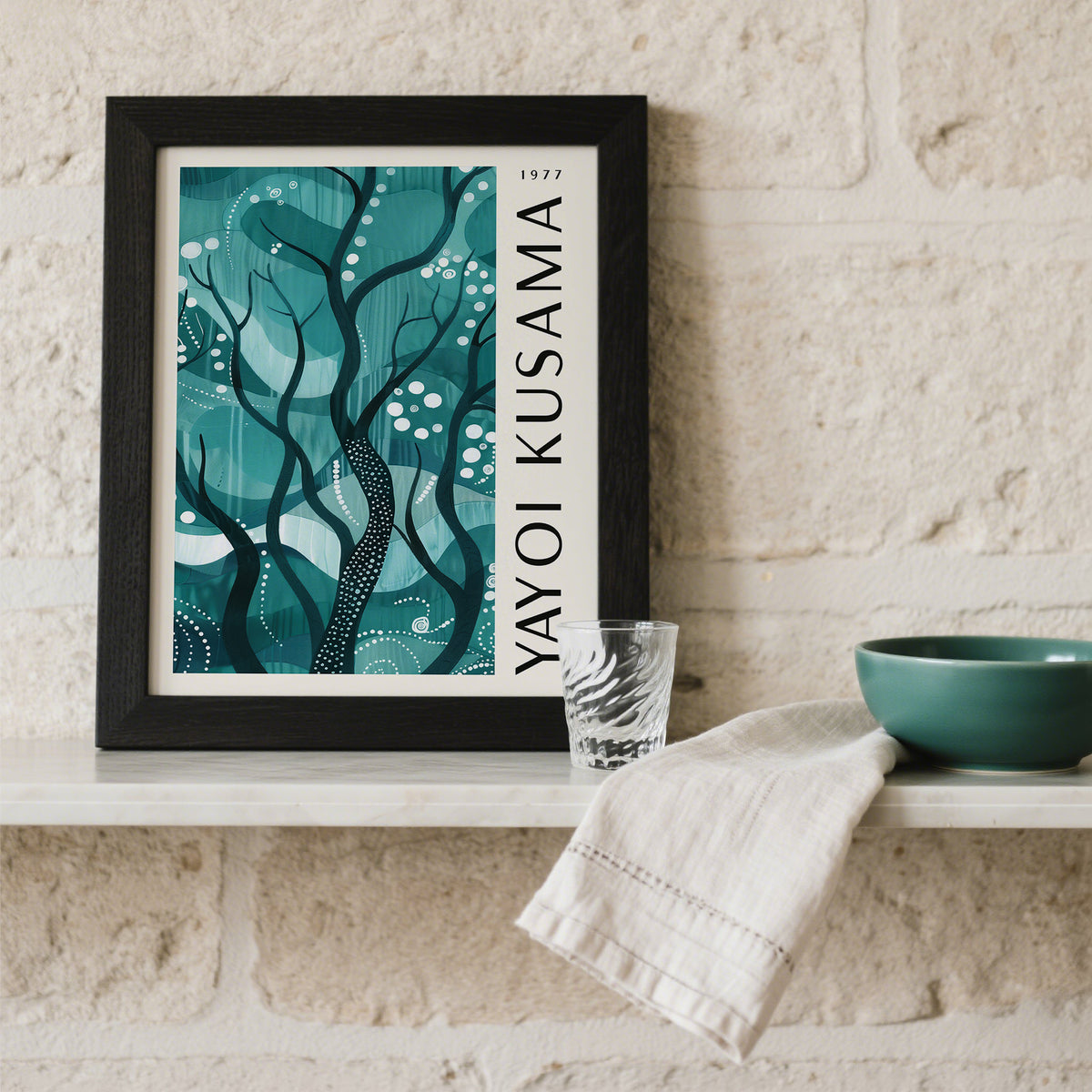 Framed Green Nature Poster with abstract forest branches in blues and greens on a shelf with glass and bowl