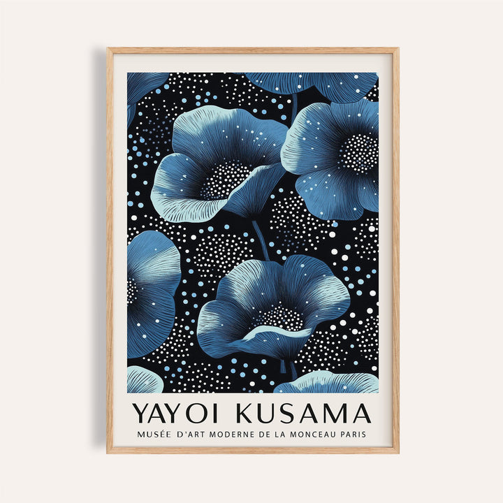 Framed print of blue flowers with white dots on black background in natural wood frame