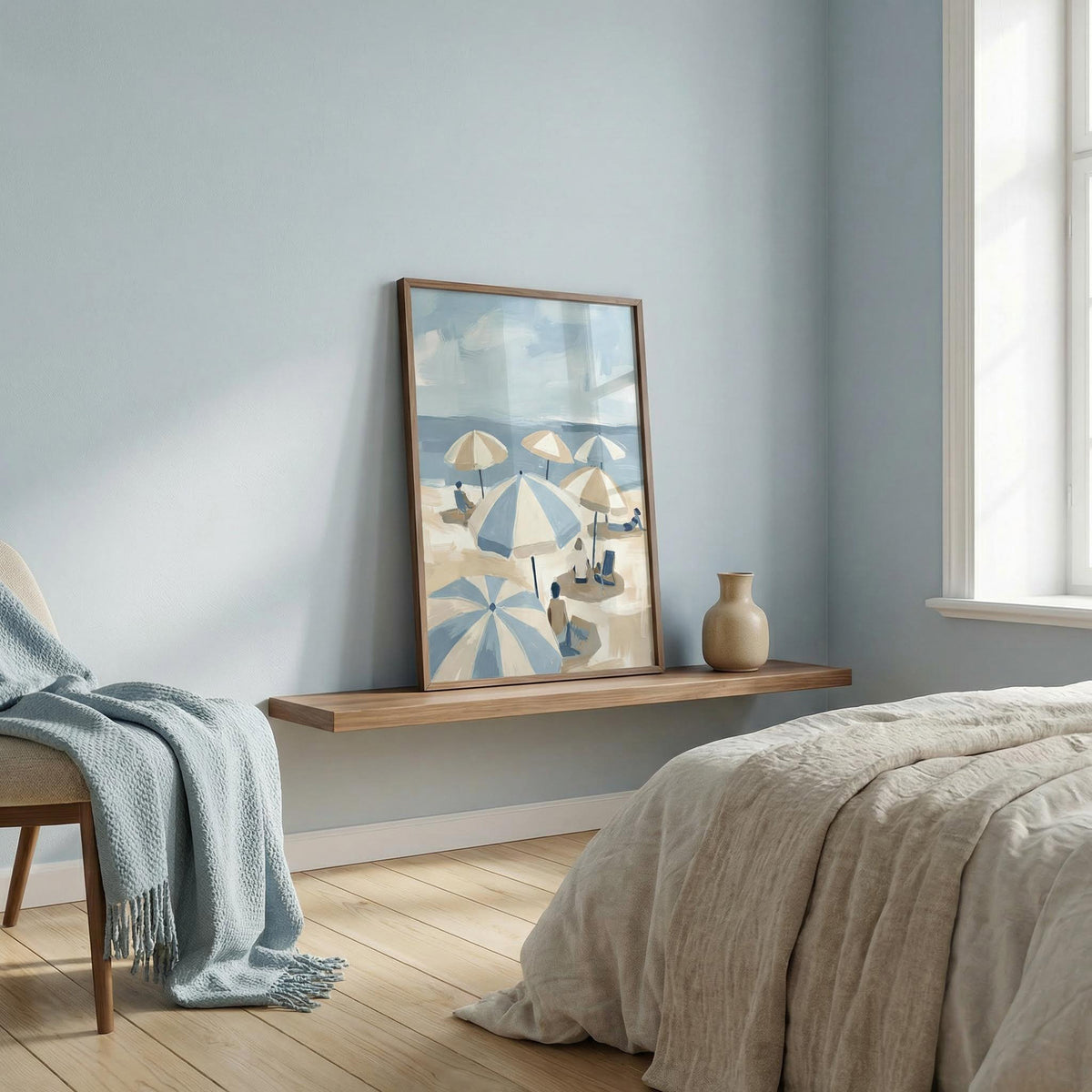 Beach Umbrella Art print leaning on a wooden shelf beside a beige vase in a soft blue bedroom
