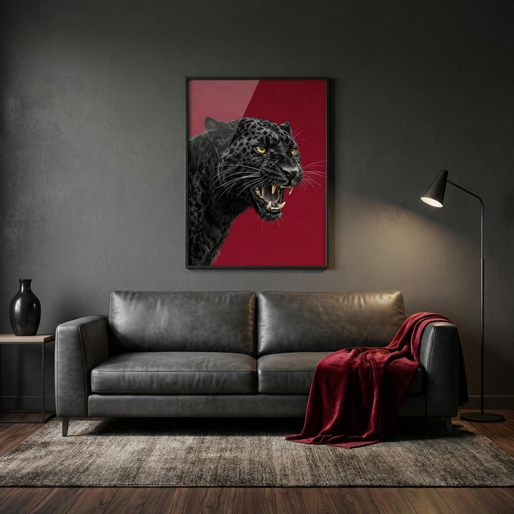 Wildlife wall art of a snarling black panther head on a red background above a leather sofa