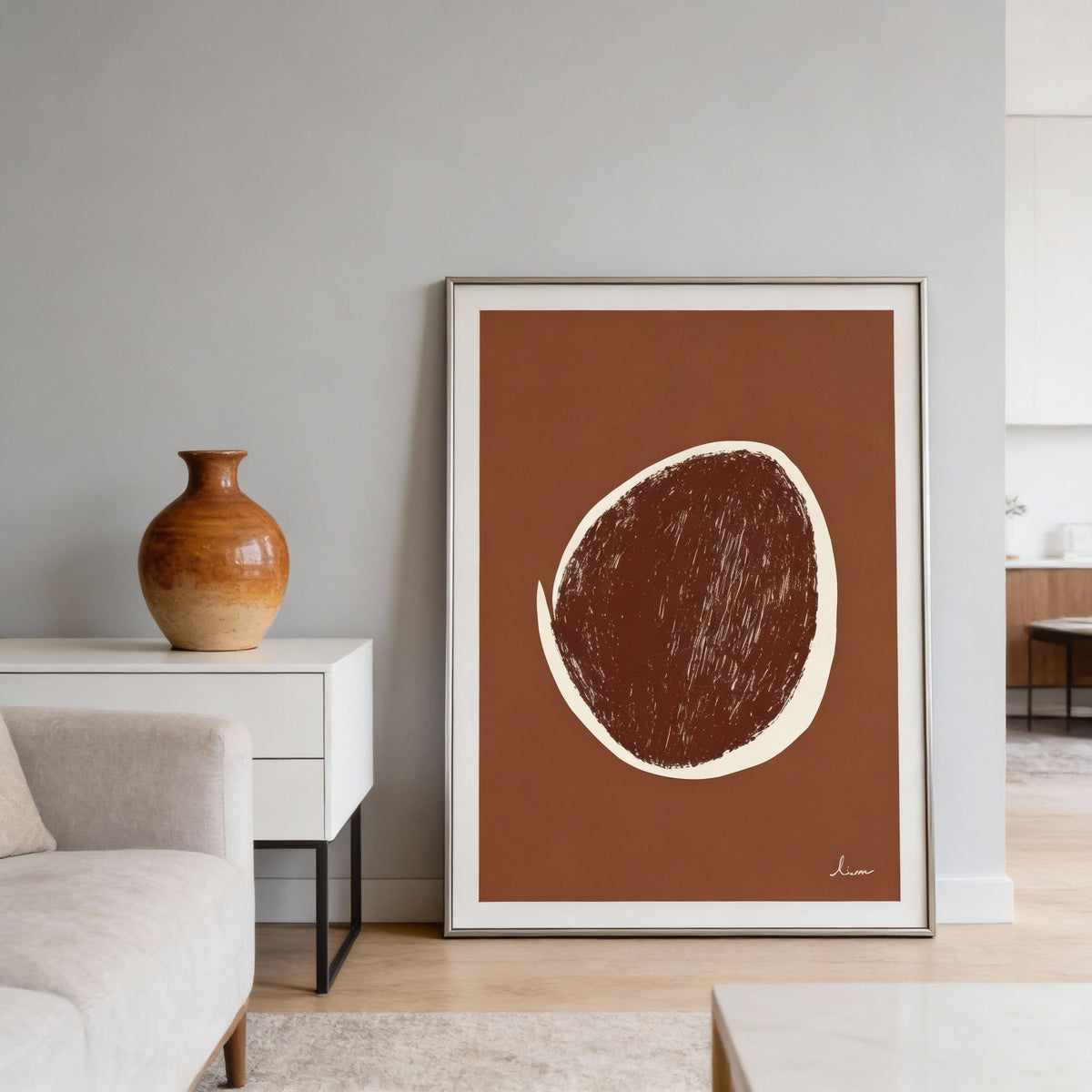Abstract Earth Tone Art Print leaning on a wooden floor next to a two-tone ceramic vase