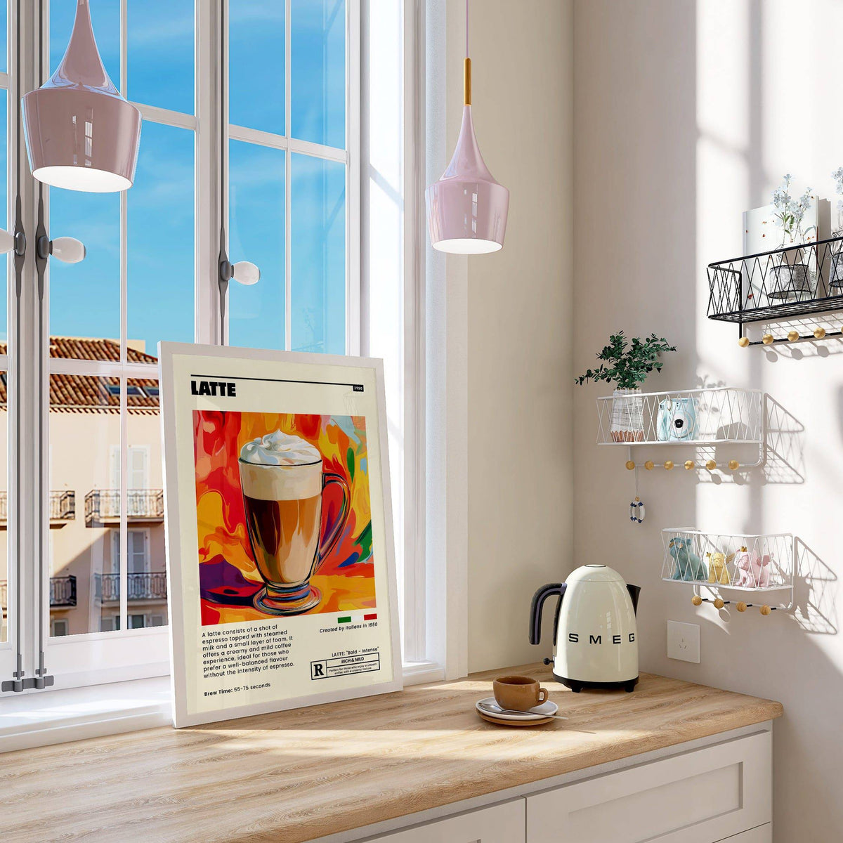 Coffee artwork prints leaning on a kitchen countertop with a pastel kettle and cup nearby