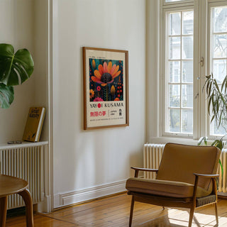 Flower wall decor of an orange flower with a black center in a bright room with a brown armchair