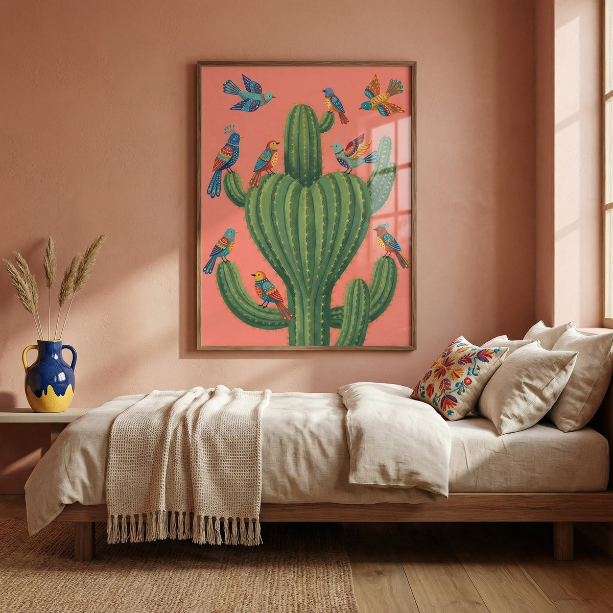 Colourful Bird Cactus Art print on a peach wall above a beige bed with patterned cushions and a vase