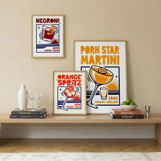 Cocktail Posters Set featuring typographic illustrations of a Negroni and other cocktails in warm colours on a shelf