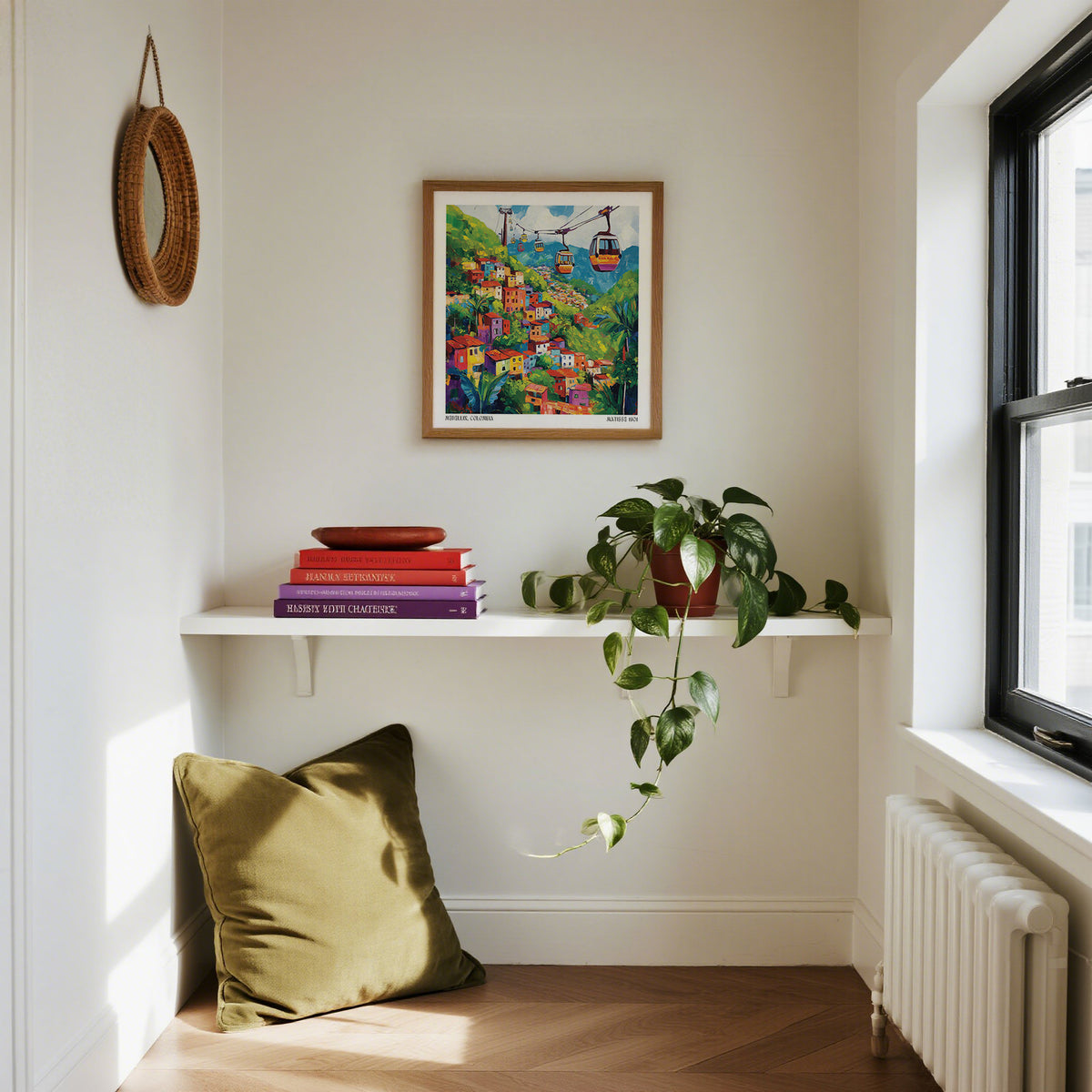 Nook with a pillow, books, and a plant by a window with a colorful painting on the wall.