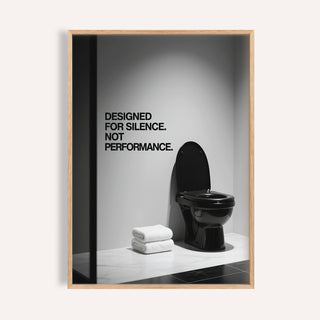 Framed Funny Toilet Wall Art with black toilet and white towels on tiled floor