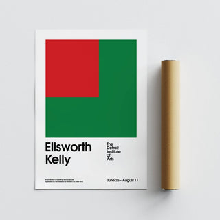 Office Poster laid flat with red and green geometric shapes next to a brown tube