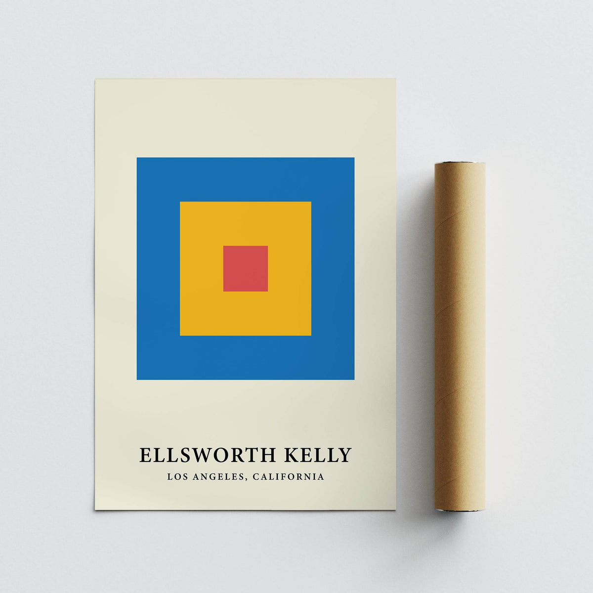Minimalist art print of concentric red yellow and blue blocks next to a brown packaging tube