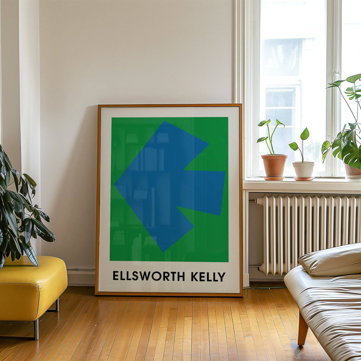 Ellsworth Kelly art print leaning against a wall with plants and furniture nearby in a living room